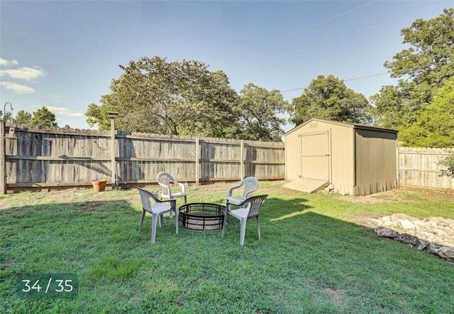 5 Horseshoe Dr, Holiday Island, AR 72631 - fenced backyard with a storage unit and an outdoor fire pit