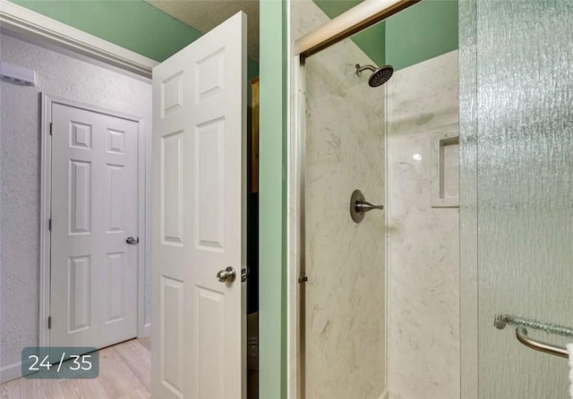 5 Horseshoe Dr, Holiday Island, AR 72631 - full bathroom with a stall shower, wood finished floors, and a textured wall