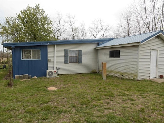 1042 County Road 445, Berryville, AR 72616 - back of property with board and batten siding, a lawn, and a metal roof