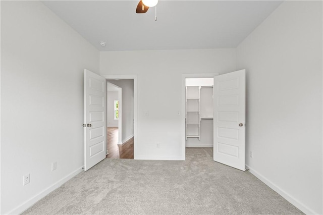 2 Wendike Ln, Bella Vista, AR 72715 - unfurnished bedroom featuring carpet, a walk in closet, a closet, and a ceiling fan