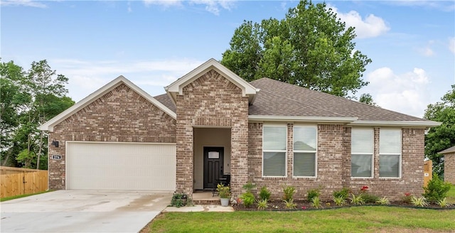 276 N Yona Ln, Farmington, AR 72730 - view of front of house featuring brick siding, an attached garage, driveway, and a shingled roof