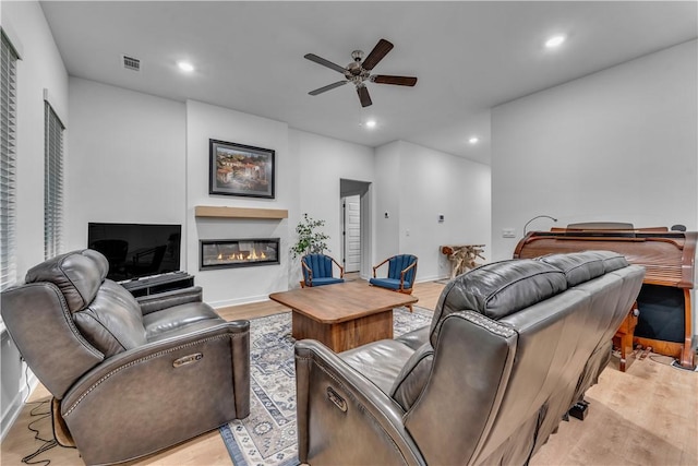 276 N Yona Ln, Farmington, AR 72730 - living area with a glass covered fireplace, a ceiling fan, light wood-style floors, and recessed lighting