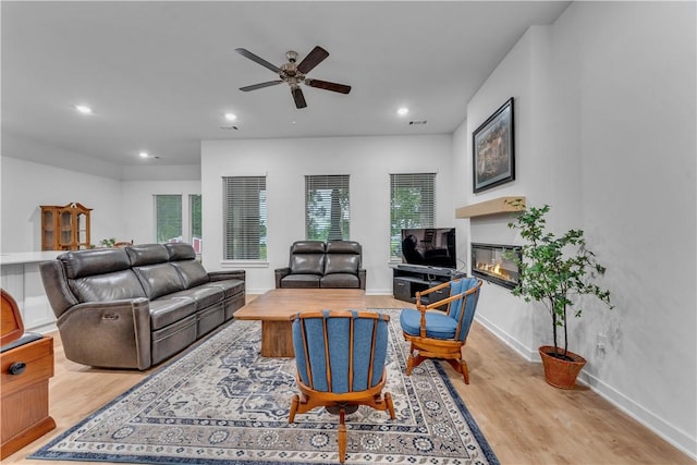 276 N Yona Ln, Farmington, AR 72730 - living room featuring wood finished floors, ceiling fan, a glass covered fireplace, and recessed lighting