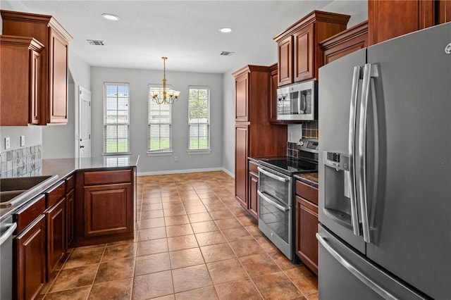 4788 Soapstone Dr, Fayetteville, AR 72704 - kitchen featuring appliances with stainless steel finishes, a chandelier, dark countertops, recessed lighting, and light tile patterned floors