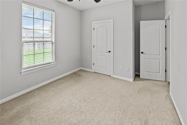 4788 Soapstone Dr, Fayetteville, AR 72704 - unfurnished bedroom with multiple windows, carpet, and a ceiling fan