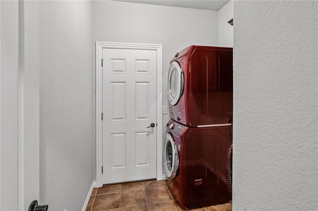 4788 Soapstone Dr, Fayetteville, AR 72704 - laundry room featuring stacked washer / drying machine, a textured wall, and tile patterned floors