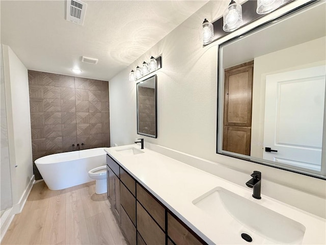 1215 John Renfro Rd, Pea Ridge, AR 72751 - bathroom featuring a freestanding tub, double vanity, and tile walls