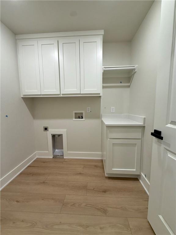 1215 John Renfro Rd, Pea Ridge, AR 72751 - washroom with electric dryer hookup, cabinet space, washer hookup, and light wood finished floors