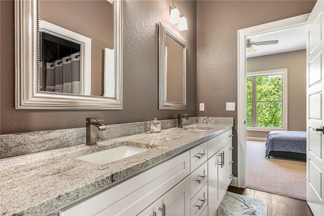 8 Mckenzie Way, Bella Vista, AR 72715 - full bath with double vanity, a textured wall, wood finished floors, and ensuite bathroom