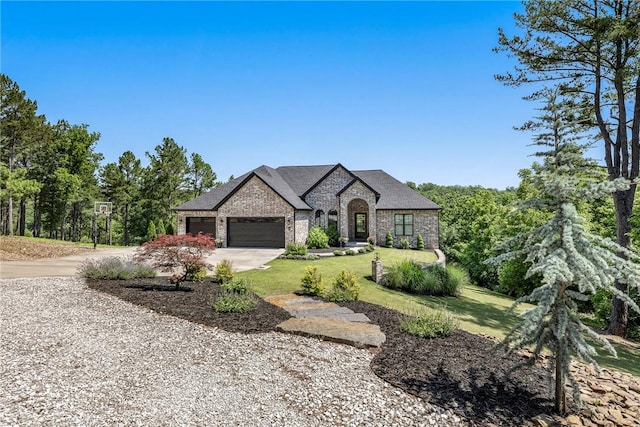 8 Mckenzie Way, Bella Vista, AR 72715 - french country home with brick siding, concrete driveway, a garage, and a front yard