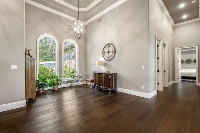 8 Mckenzie Way, Bella Vista, AR 72715 - foyer entrance with dark wood finished floors, ornamental molding, a high ceiling, and a chandelier