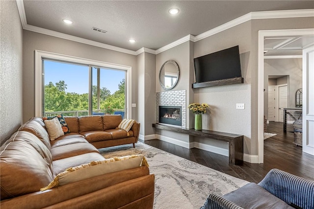 8 Mckenzie Way, Bella Vista, AR 72715 - living area featuring a tiled fireplace, dark wood-style floors, crown molding, and recessed lighting