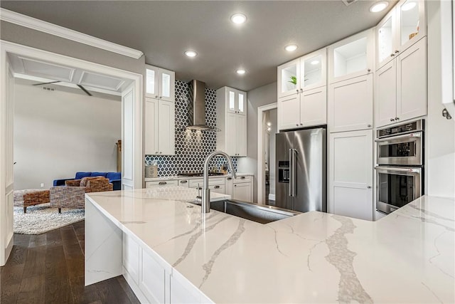 8 Mckenzie Way, Bella Vista, AR 72715 - kitchen with appliances with stainless steel finishes, wall chimney range hood, recessed lighting, backsplash, and white cabinets