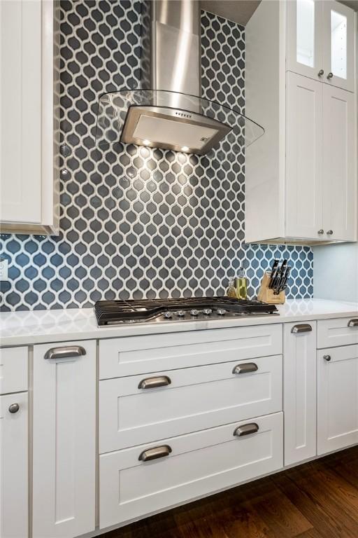 8 Mckenzie Way, Bella Vista, AR 72715 - kitchen with wall chimney range hood, light countertops, stainless steel gas stovetop, and tasteful backsplash