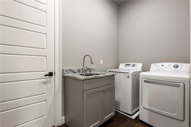 8 Mckenzie Way, Bella Vista, AR 72715 - laundry area featuring a textured wall, washing machine and clothes dryer, dark wood-style floors, and cabinet space
