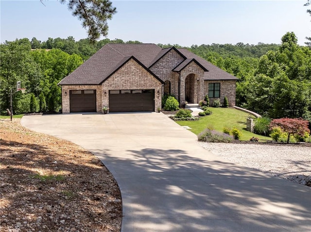 8 Mckenzie Way, Bella Vista, AR 72715 - french country inspired facade with brick siding, a garage, concrete driveway, and a front lawn