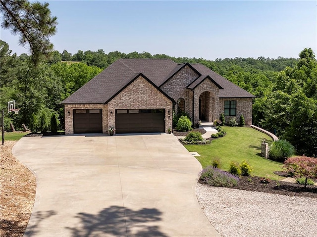 8 Mckenzie Way, Bella Vista, AR 72715 - french country home with brick siding, concrete driveway, a garage, and a front lawn