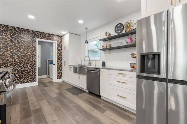 3902 Layton Dr, Harrison, AR 72601 - kitchen featuring stainless steel appliances, light stone countertops, wallpapered walls, white cabinets, and dark wood-type flooring