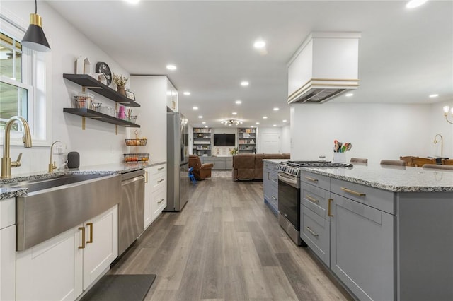 3902 Layton Dr, Harrison, AR 72601 - kitchen featuring appliances with stainless steel finishes, gray cabinets, open floor plan, light stone counters, and white cabinetry