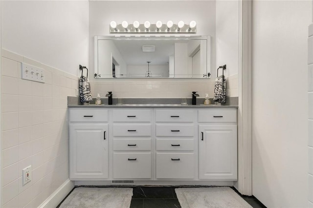 3902 Layton Dr, Harrison, AR 72601 - bathroom with double vanity, tile walls, and tile patterned floors
