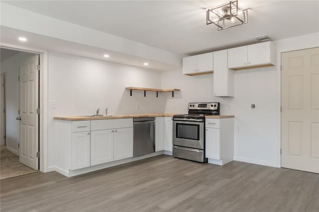 3902 Layton Dr, Harrison, AR 72601 - kitchen with stainless steel appliances, open shelves, recessed lighting, light wood-type flooring, and white cabinets
