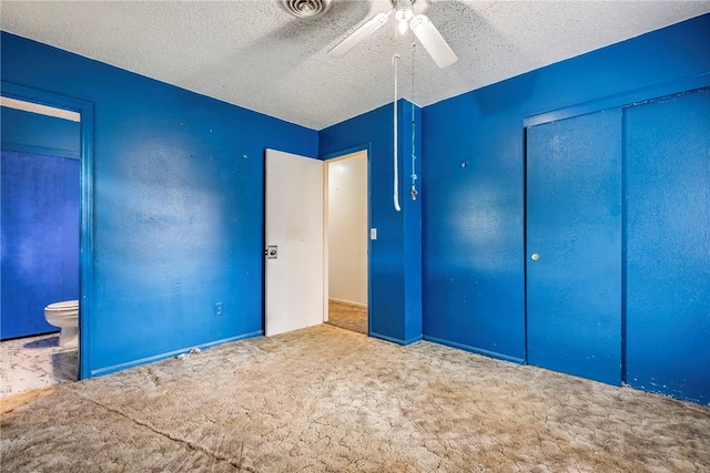 2000 W Wood St, Rogers, AR 72756 - unfurnished bedroom featuring carpet floors, a closet, ceiling fan, ensuite bathroom, and a textured ceiling
