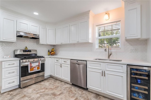 1209 W Olive St, Rogers, AR 72756 - kitchen featuring wine cooler, appliances with stainless steel finishes, under cabinet range hood, white cabinetry, and light countertops