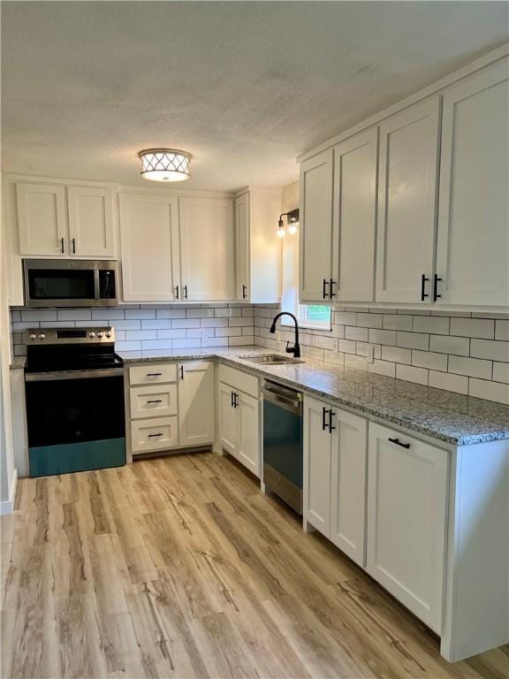 3501 Pleasant, Ozark, AR 72949 - kitchen with stainless steel appliances, white cabinetry, decorative backsplash, and light stone counters