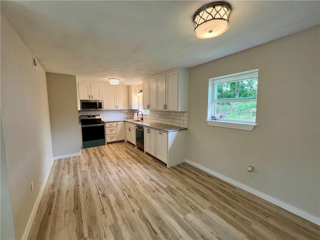 3501 Pleasant, Ozark, AR 72949 - kitchen with appliances with stainless steel finishes, light wood-style floors, decorative backsplash, and white cabinetry