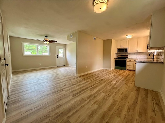 3501 Pleasant, Ozark, AR 72949 - kitchen with stainless steel microwave, range with electric cooktop, open floor plan, light wood-style floors, and ceiling fan