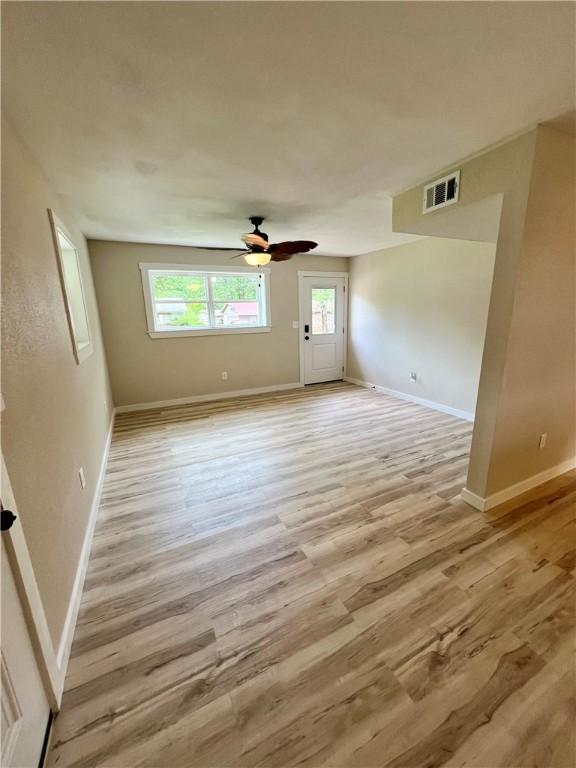 3501 Pleasant, Ozark, AR 72949 - spare room with light wood finished floors and ceiling fan