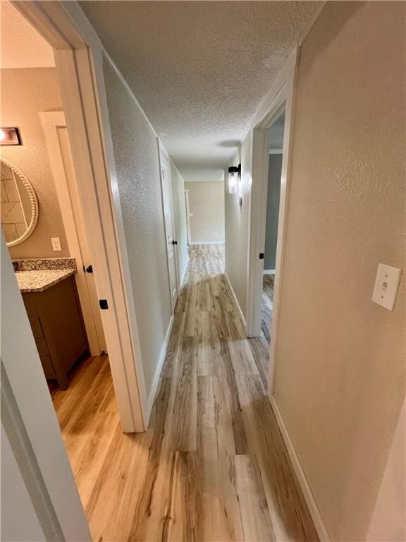 3501 Pleasant, Ozark, AR 72949 - hallway with a textured ceiling, a textured wall, and light wood-style flooring