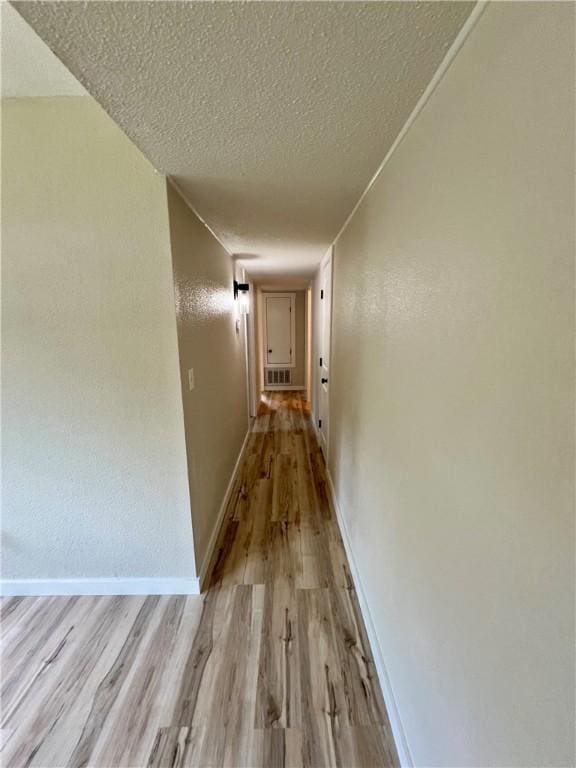 3501 Pleasant, Ozark, AR 72949 - hall with light wood-style flooring and a textured ceiling
