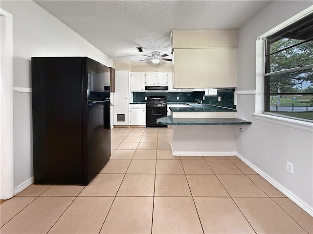 1906 S W End St, Springdale, AR 72764 - kitchen featuring black appliances, dark countertops, a peninsula, light tile patterned flooring, and ceiling fan