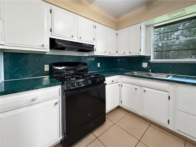 1906 S W End St, Springdale, AR 72764 - kitchen featuring black gas range oven, under cabinet range hood, a textured ceiling, dark countertops, and white cabinets