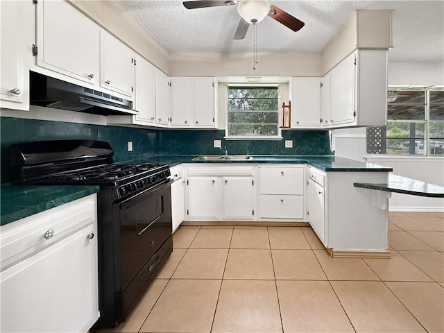 1906 S W End St, Springdale, AR 72764 - kitchen with black gas range, under cabinet range hood, dark countertops, white cabinetry, and a textured ceiling