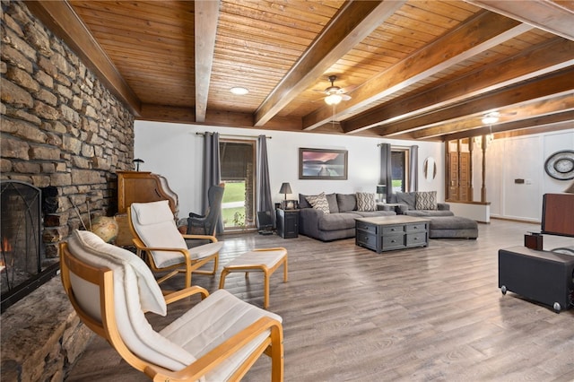 213 Suttle Dr, Springdale, AR 72764 - living room featuring a wood ceiling with exposed beams, a ceiling fan, wood finished floors, and a fireplace