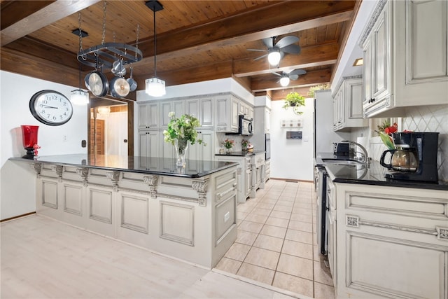 213 Suttle Dr, Springdale, AR 72764 - kitchen with a wooden ceiling with exposed beams, dark countertops, a peninsula, stainless steel microwave, and ceiling fan