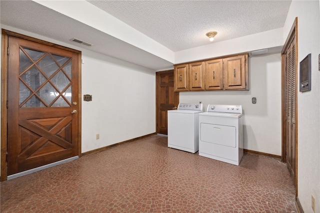 213 Suttle Dr, Springdale, AR 72764 - laundry room featuring independent washer and dryer, cabinet space, and a textured ceiling