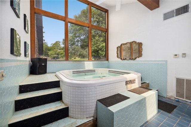 213 Suttle Dr, Springdale, AR 72764 - bathroom featuring tile patterned floors, a bath, and wainscoting