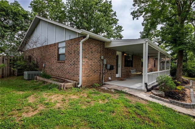 707 Turtle Creek Dr, Rogers, AR 72756 - view of side of property featuring brick siding, board and batten siding, and a patio area