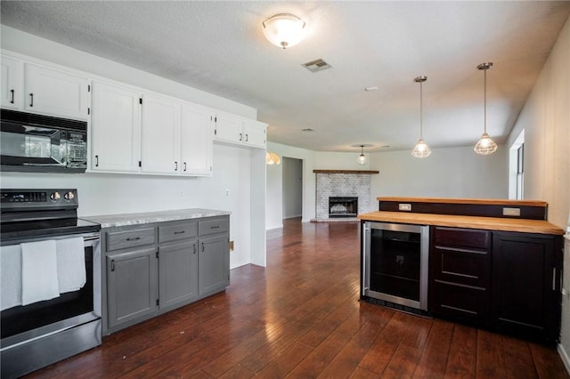707 Turtle Creek Dr, Rogers, AR 72756 - kitchen with stainless steel electric range oven, beverage cooler, black microwave, white cabinets, and dark wood-style flooring
