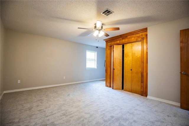 707 Turtle Creek Dr, Rogers, AR 72756 - unfurnished bedroom featuring carpet, a textured ceiling, a closet, and a ceiling fan