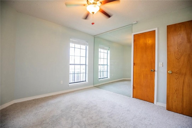 707 Turtle Creek Dr, Rogers, AR 72756 - unfurnished bedroom with carpet, a ceiling fan, and a textured ceiling