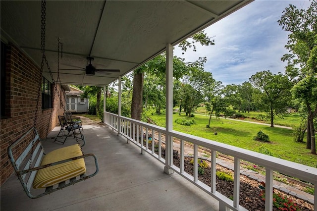 707 Turtle Creek Dr, Rogers, AR 72756 - view of patio / terrace featuring a storage shed, a ceiling fan, and view of wooded area