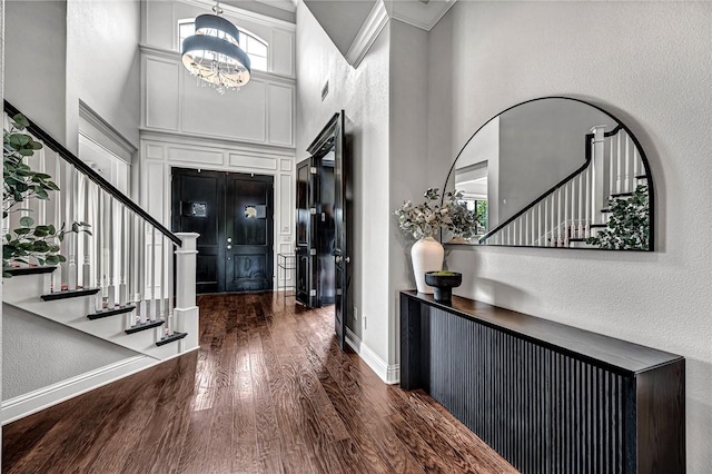 601 Chattin Cir, Bentonville, AR 72713 - entrance foyer featuring stairway, a towering ceiling, wood finished floors, a chandelier, and a textured wall