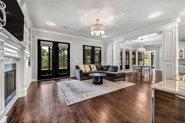 601 Chattin Cir, Bentonville, AR 72713 - living room with a chandelier, french doors, a fireplace, dark wood finished floors, and crown molding
