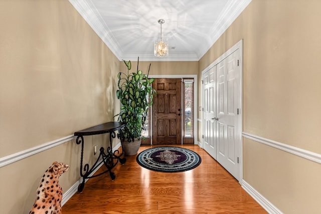 8270 Titleist Cir, Rogers, AR 72756 - entrance foyer featuring wood finished floors, ornamental molding, and a chandelier