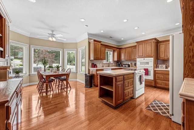 8270 Titleist Cir, Rogers, AR 72756 - kitchen with white appliances, light countertops, open shelves, brown cabinets, and recessed lighting