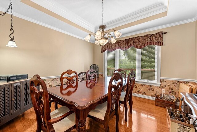 8270 Titleist Cir, Rogers, AR 72756 - dining room with a chandelier, crown molding, light wood-style floors, and a tray ceiling